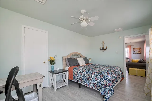 a bedroom with a bed and a chandelier