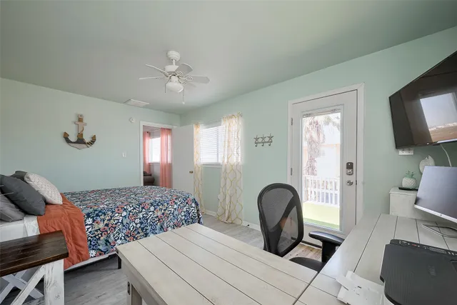 a bedroom with a bed and ceiling fan