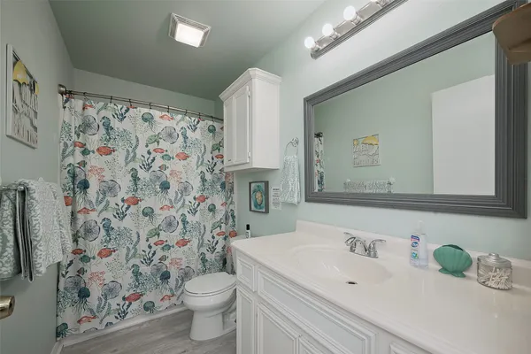 a bathroom with a sink toilet and shower