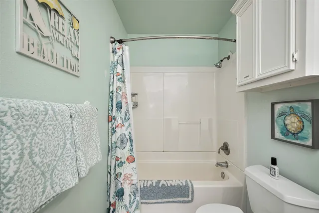 a bathroom with a bathtub and shower