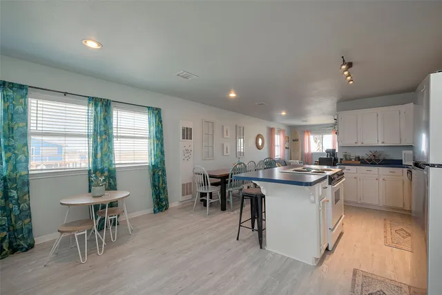 a kitchen with lots of counter top space and dining table