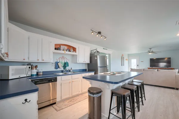 a kitchen with granite countertop a sink and cabinets