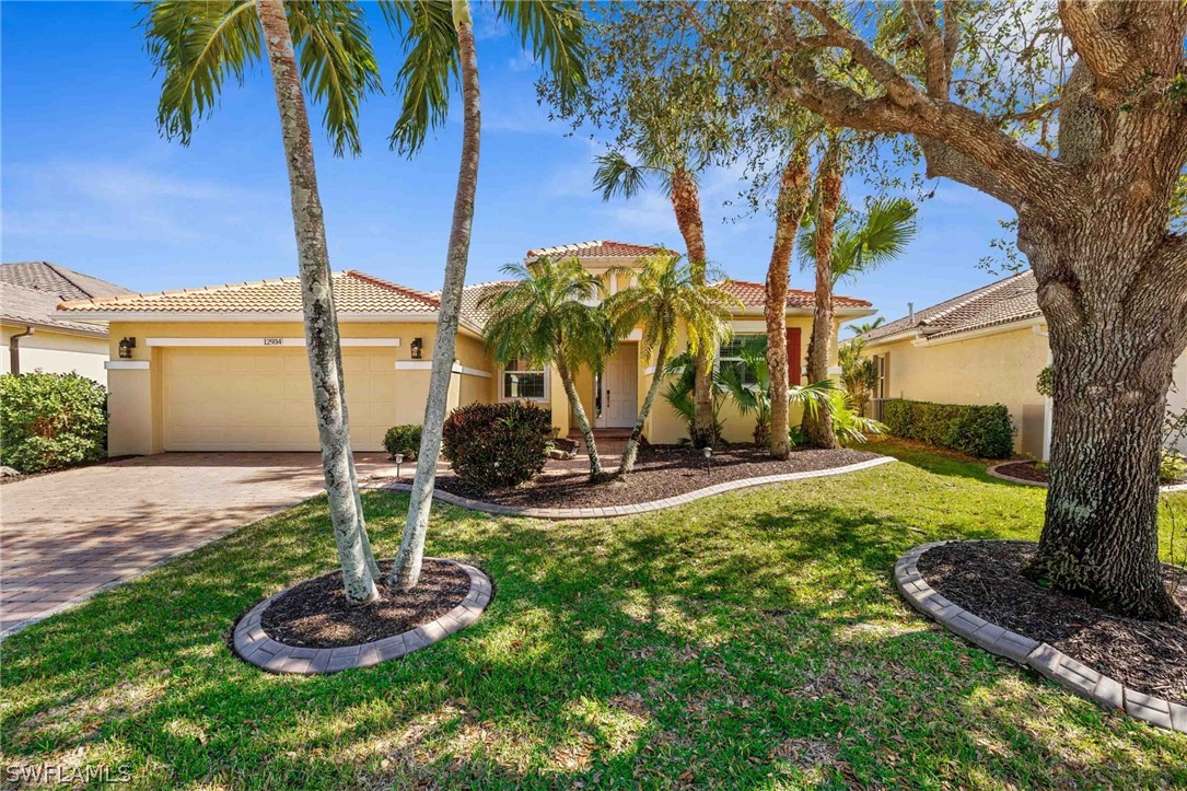 12934 Timber Ridge Drive Fort Myers, FL 33913 - Photo 1 of 24 a view of a house with a yard