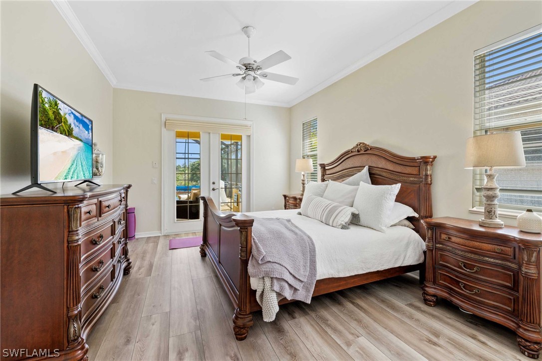 12934 Timber Ridge Drive Fort Myers, FL 33913 - Photo 12 of 24 a bedroom with a bed and a flat tv screen on dresser