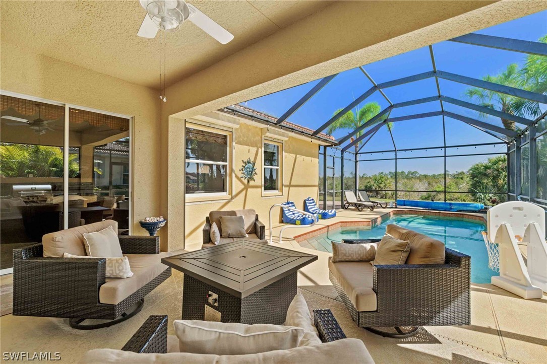 12934 Timber Ridge Drive Fort Myers, FL 33913 - Photo 19 of 24 a living room with patio furniture and a umbrella