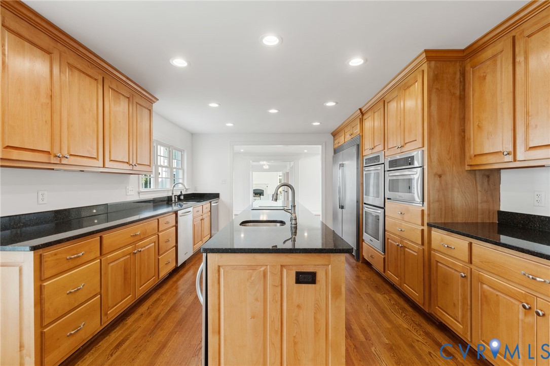 189 Old Buckingham Road Cumberland, VA 23040 - Photo 19 of 50 a open kitchen with kitchen island granite countertop wooden cabinets a sink and dishwasher