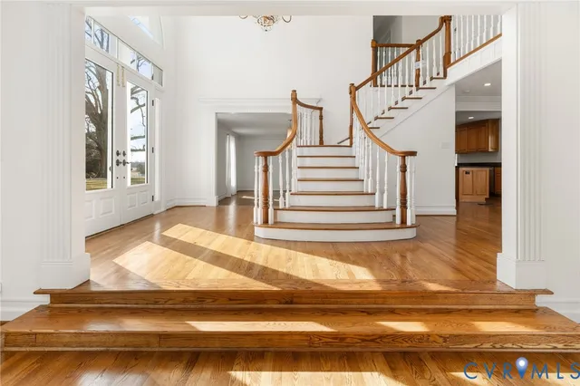 a view of entryway and hall with wooden floor