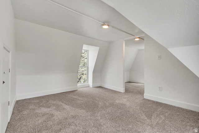8831 South 400 East Sandy, UT 84070 - Photo 24 of 26 Bonus room with carpet floors and vaulted ceiling