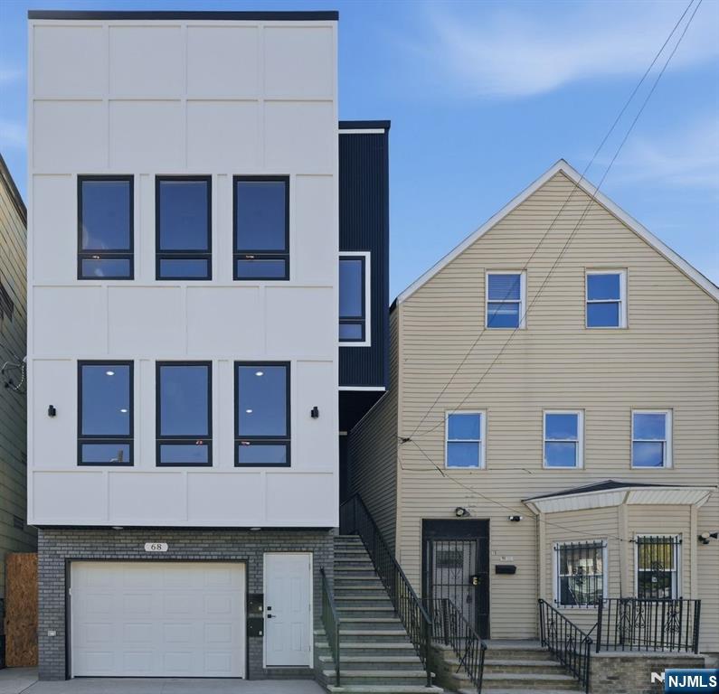 68 Sherman Avenue Newark, NJ 07114 - Photo 1 of 37 a view of a house with a garage