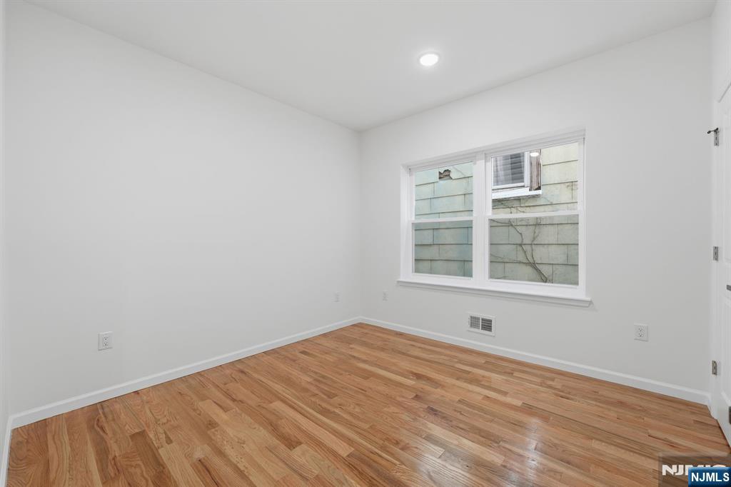 68 Sherman Avenue Newark, NJ 07114 - Photo 12 of 37 wooden floor in an empty room with a window