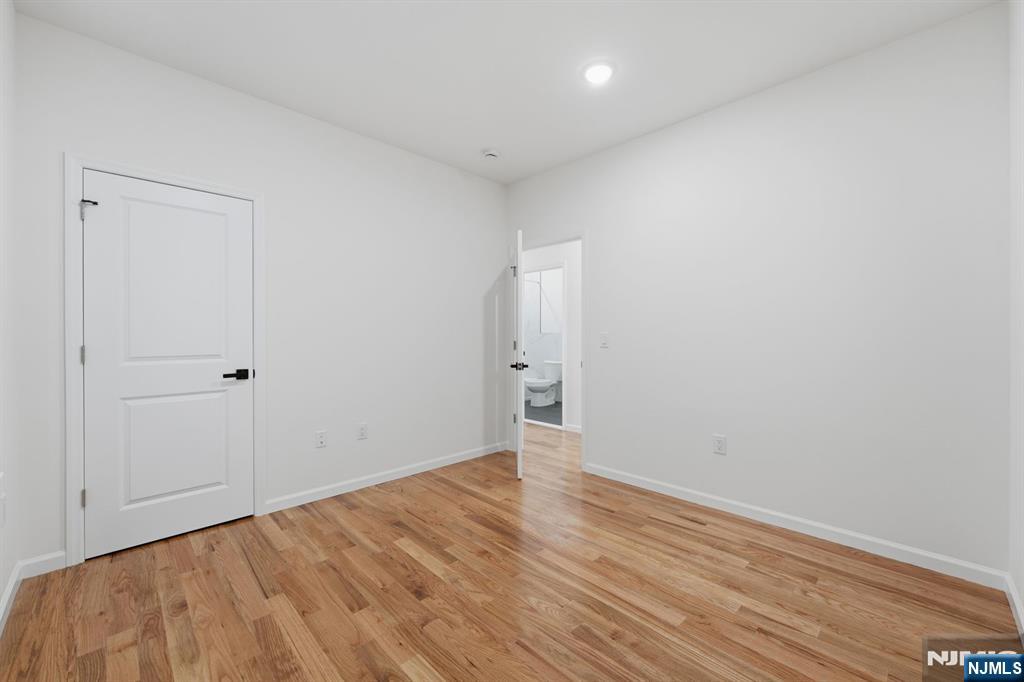 68 Sherman Avenue Newark, NJ 07114 - Photo 13 of 37 a view of an empty room with wooden floor