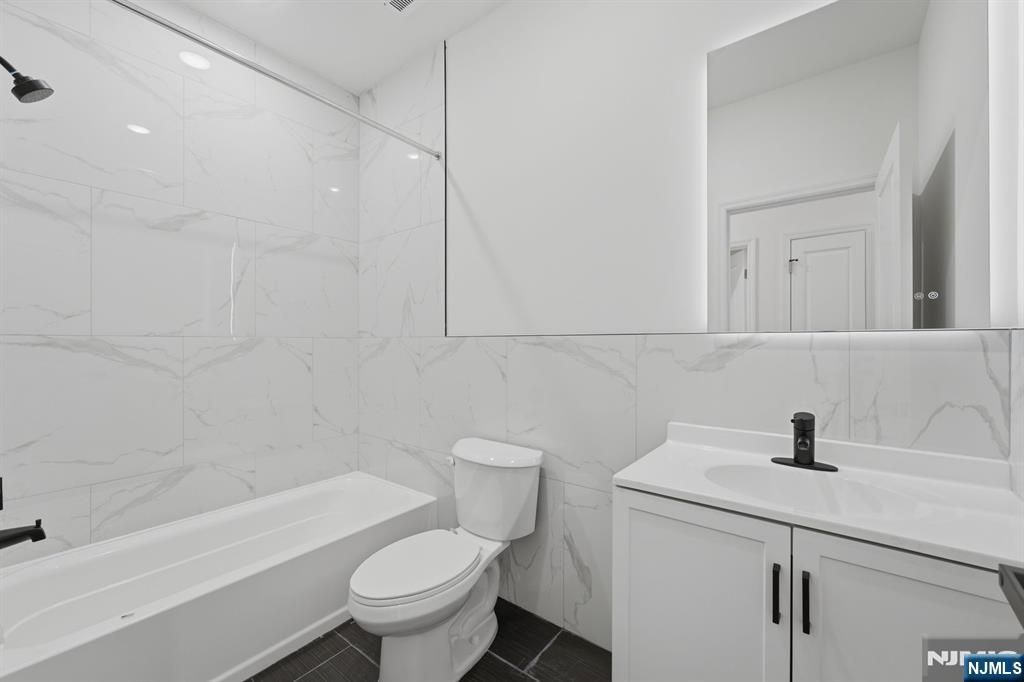 68 Sherman Avenue Newark, NJ 07114 - Photo 14 of 37 a bathroom with a sink a toilet and a bathtub