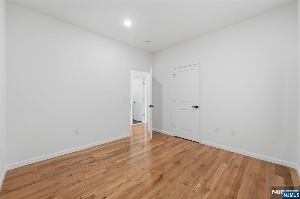 68 Sherman Avenue Newark, NJ 07114 - Photo 16 of 37 a view of an empty room with wooden floor