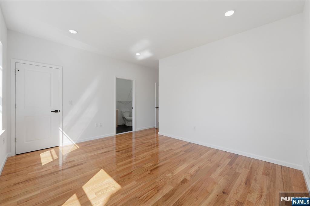 68 Sherman Avenue Newark, NJ 07114 - Photo 18 of 37 a view of an empty room with wooden floor