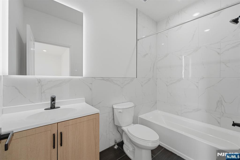 68 Sherman Avenue Newark, NJ 07114 - Photo 19 of 37 a bathroom with a sink a toilet and a bathtub