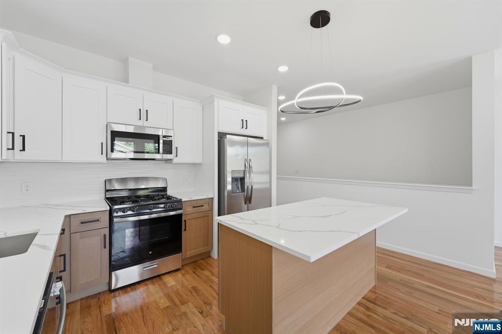 68 Sherman Avenue Newark, NJ 07114 - Photo 24 of 37 a kitchen with a stove a refrigerator and a sink