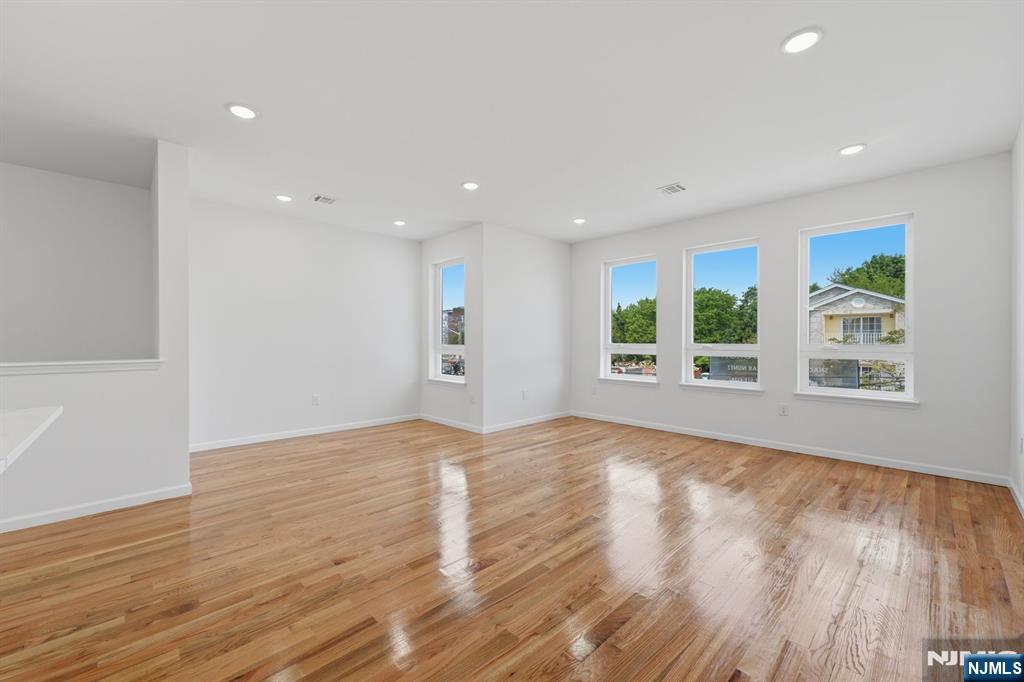 68 Sherman Avenue Newark, NJ 07114 - Photo 25 of 37 a view of an empty room with wooden floor and a window