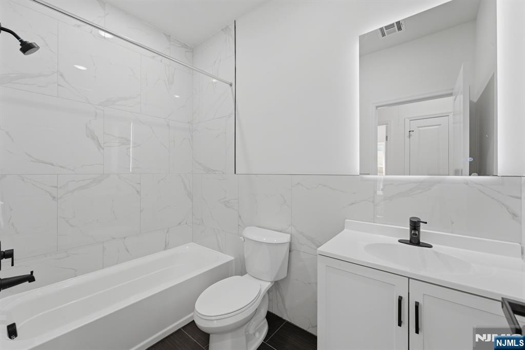 68 Sherman Avenue Newark, NJ 07114 - Photo 30 of 37 a bathroom with a sink a toilet and shower
