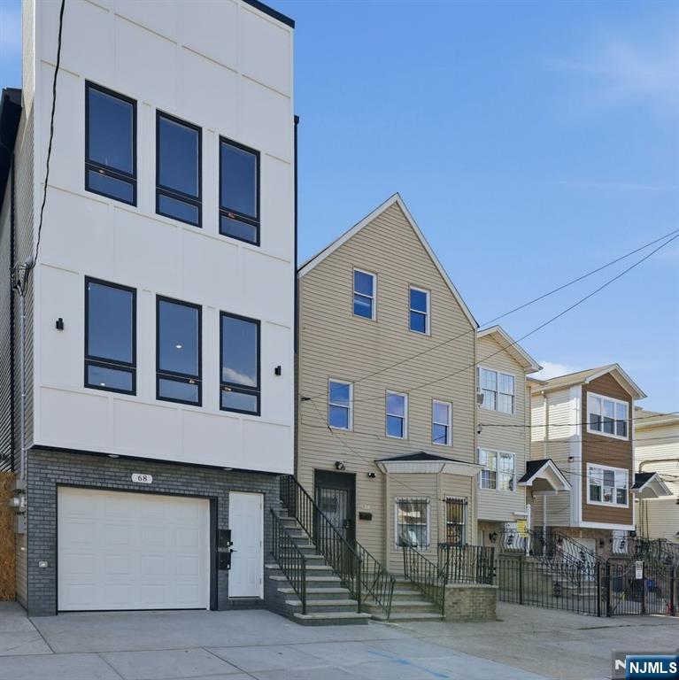 68 Sherman Avenue Newark, NJ 07114 - Photo 3 of 37 a front view of a building with many windows