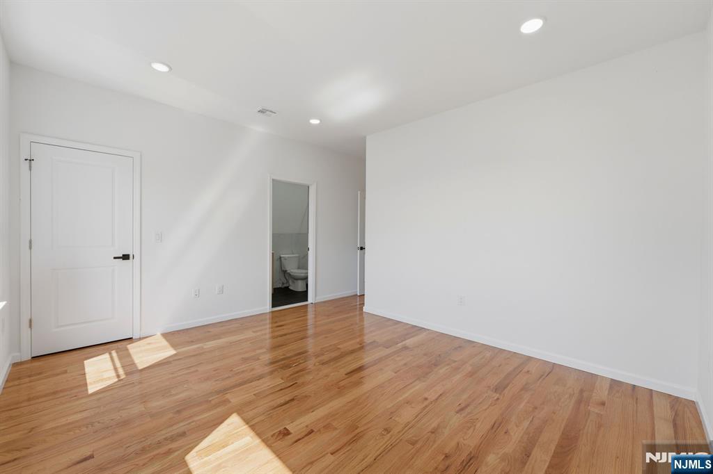 68 Sherman Avenue Newark, NJ 07114 - Photo 34 of 37 a view of an empty room with wooden floor