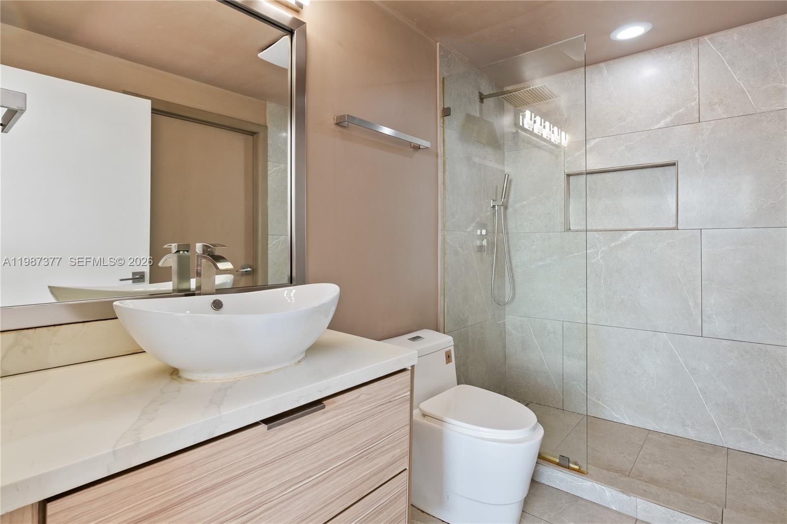 90 Southwest 3rd Street, Unit 4301 Miami, FL 33130 - Photo 13 of 18 a bathroom with a white toilet a sink and shower