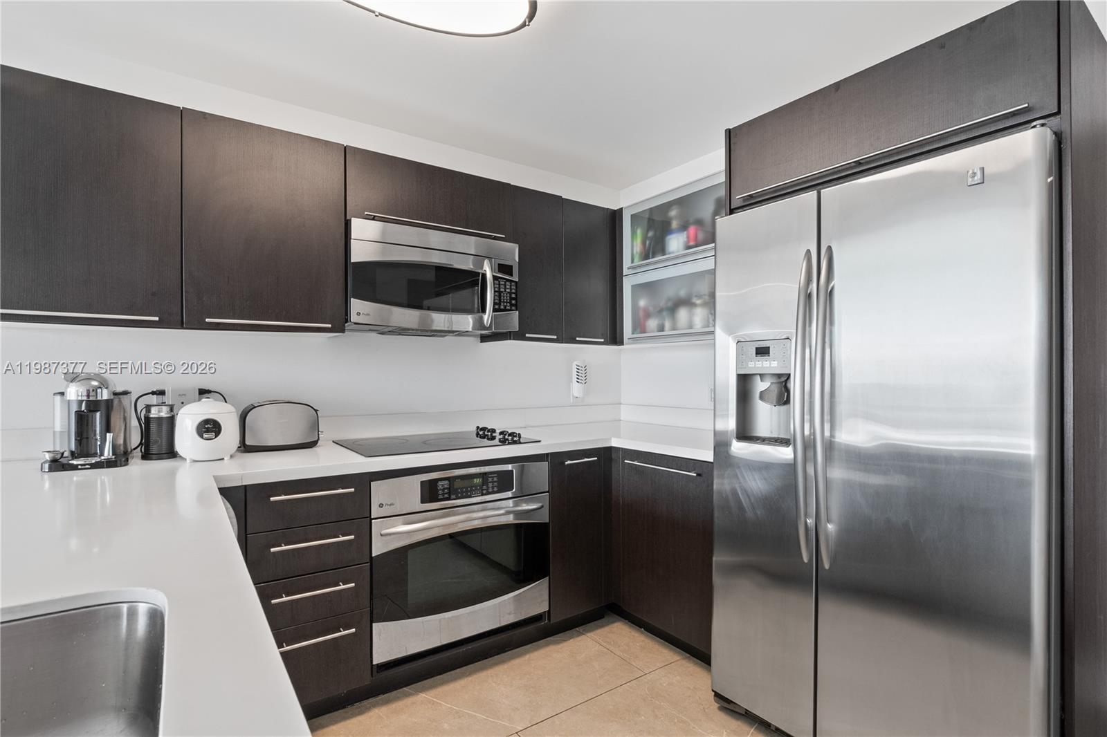 90 Southwest 3rd Street, Unit 4301 Miami, FL 33130 - Photo 8 of 18 a kitchen with a refrigerator stove and microwave