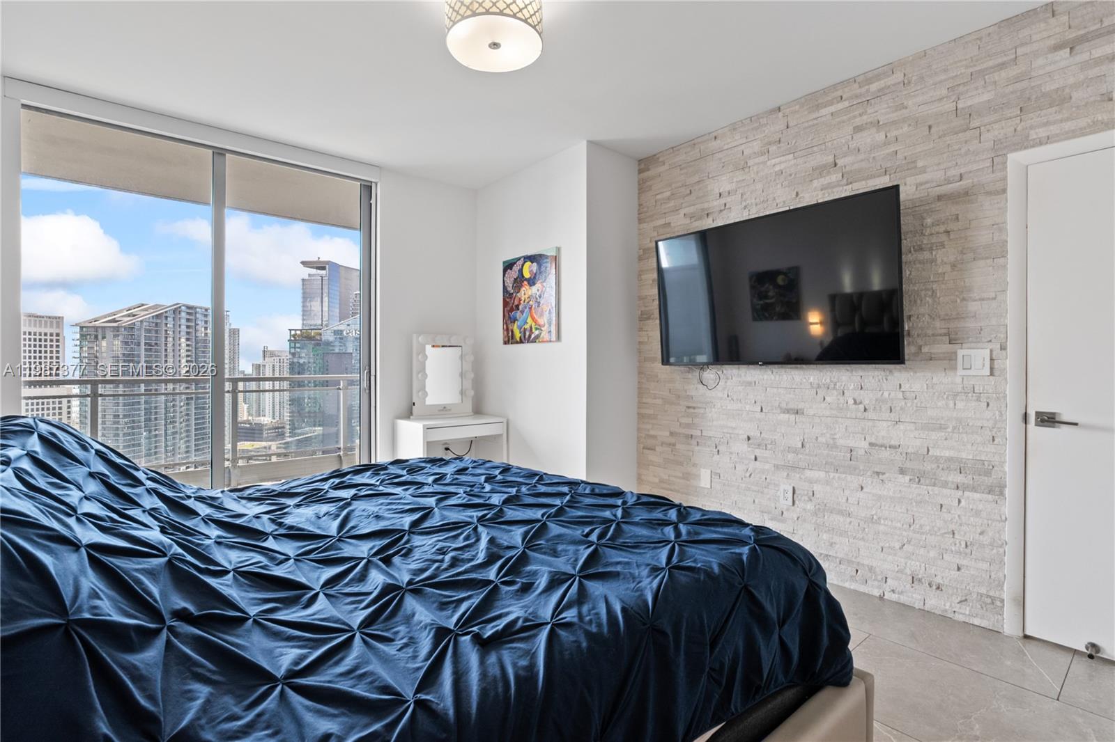90 Southwest 3rd Street, Unit 4301 Miami, FL 33130 - Photo 10 of 18 a bedroom with a bed and glass wall