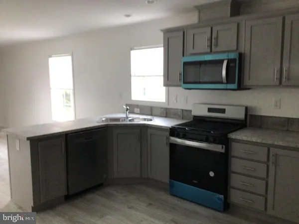 a kitchen with a sink stove and microwave