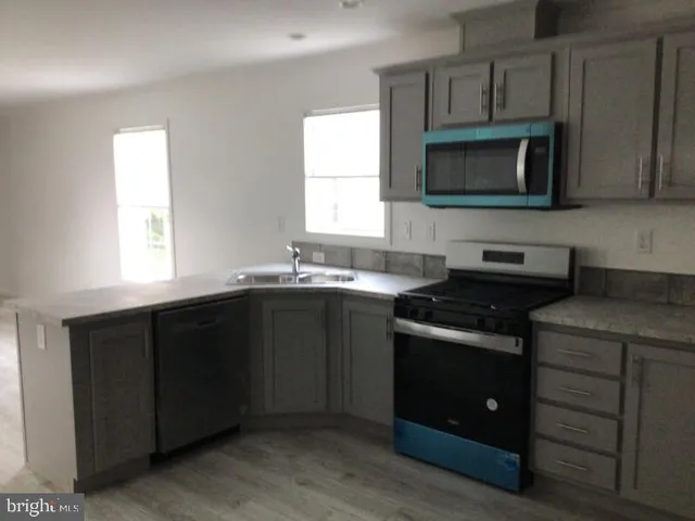a kitchen with a sink stove and microwave