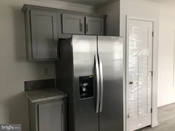 a kitchen with metallic refrigerator freezer and a dishwasher