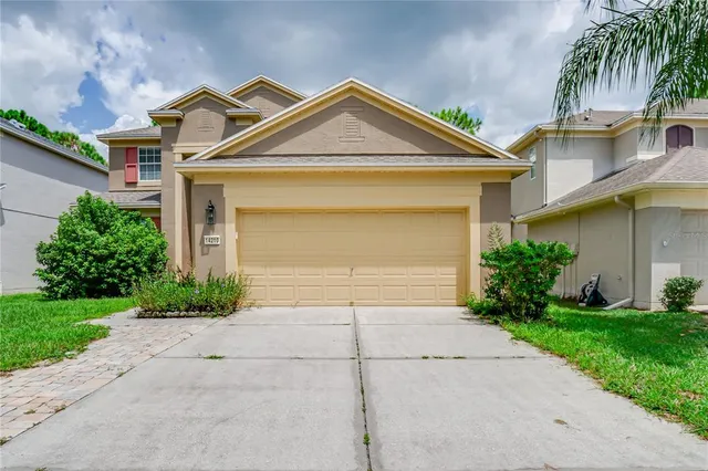a front view of a house with a yard and garage