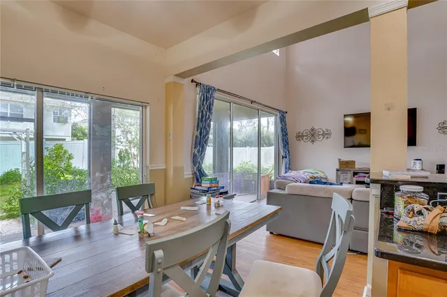 a living room filled with furniture and floor to ceiling windows