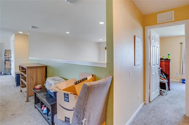 a room with a dresser and a chandelier