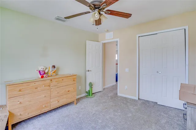 a bedroom that has a bed and a baby bed