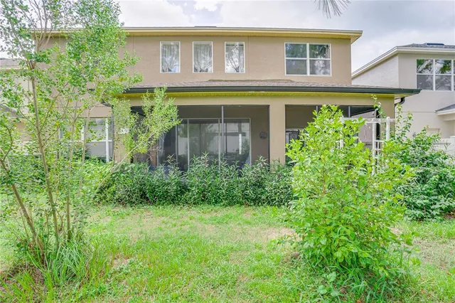 a front view of a house with a yard and green space
