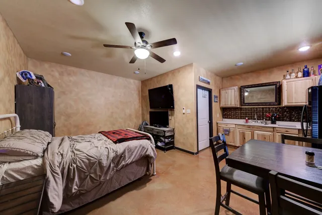 a bedroom with a bed and a flat screen tv