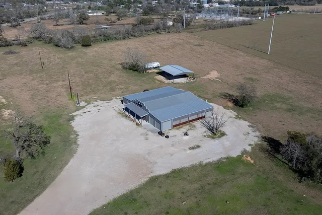 an aerial view of ocean with residential house and outdoor space