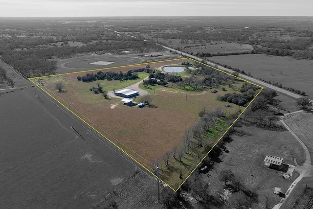 an aerial view of a residential houses with outdoor space