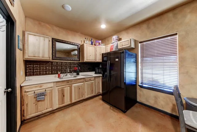 a kitchen with stainless steel appliances granite countertop a sink and a stove