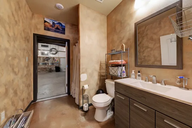 a bathroom with a toilet sink and mirror