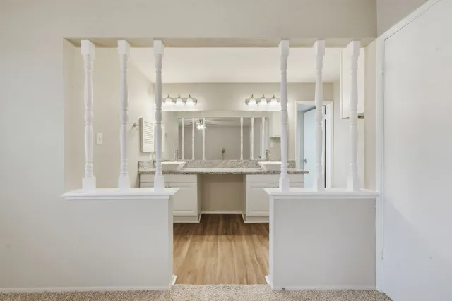 a bathroom with a granite countertop sink and a mirror
