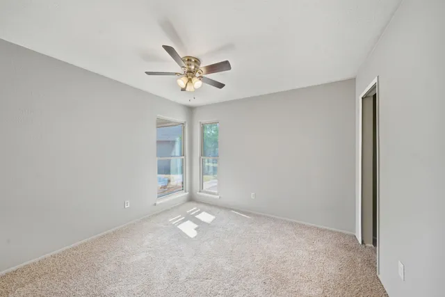a bathroom with a granite countertop sink toilet a large mirror a bathtub and shower