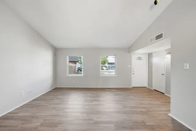 a view of wooden floor and windows in a room