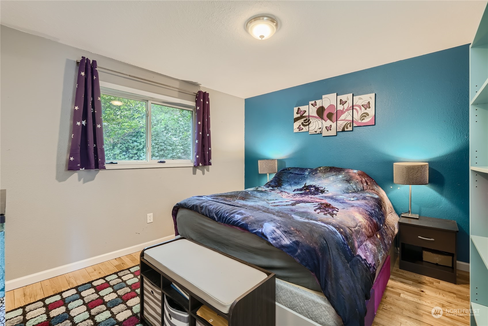 6935 24th Avenue Southwest Seattle, WA 98106 - Photo 15 of 27 a bedroom with a bed and a painting on the wall
