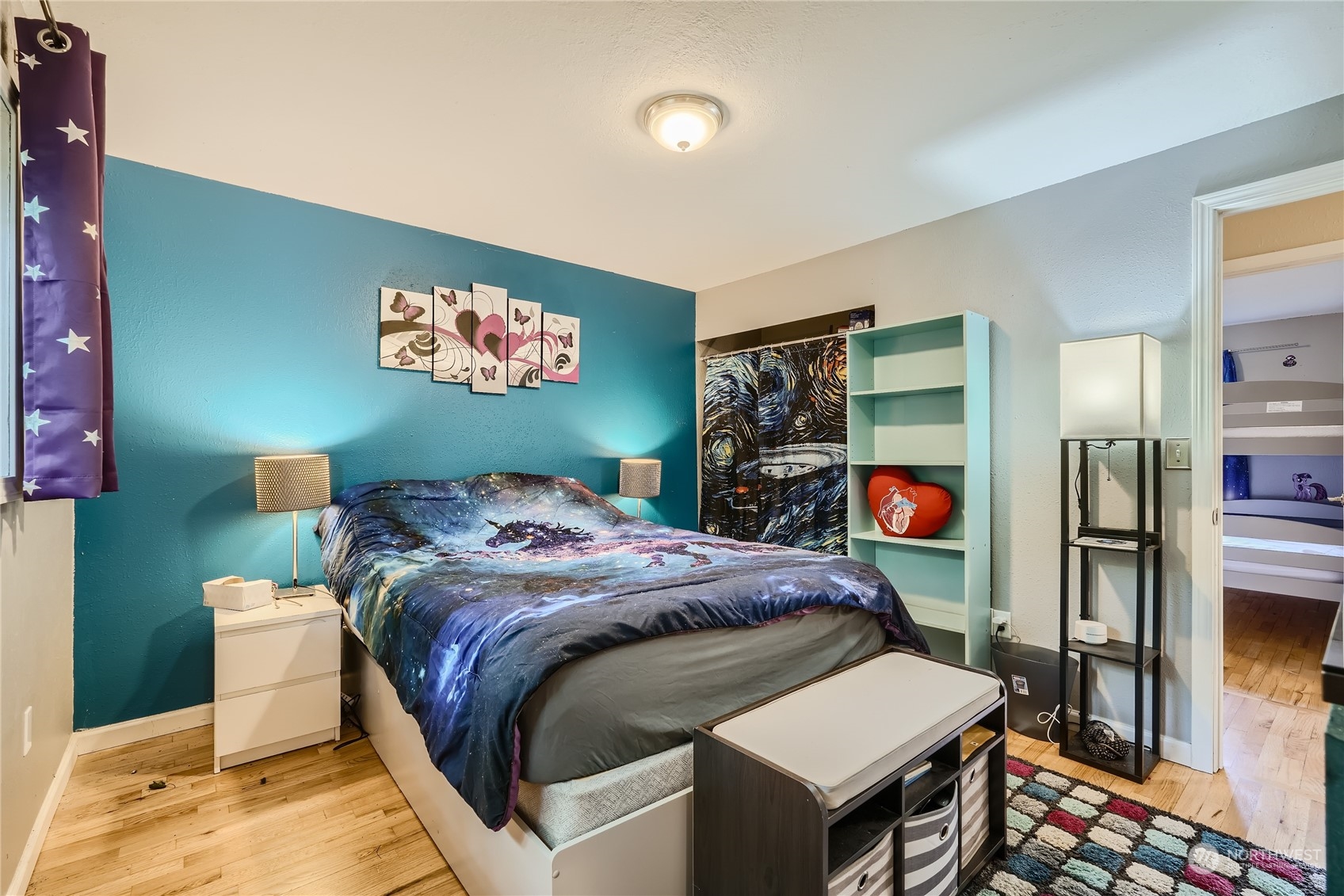 6935 24th Avenue Southwest Seattle, WA 98106 - Photo 16 of 27 a bed room with a bed and a television