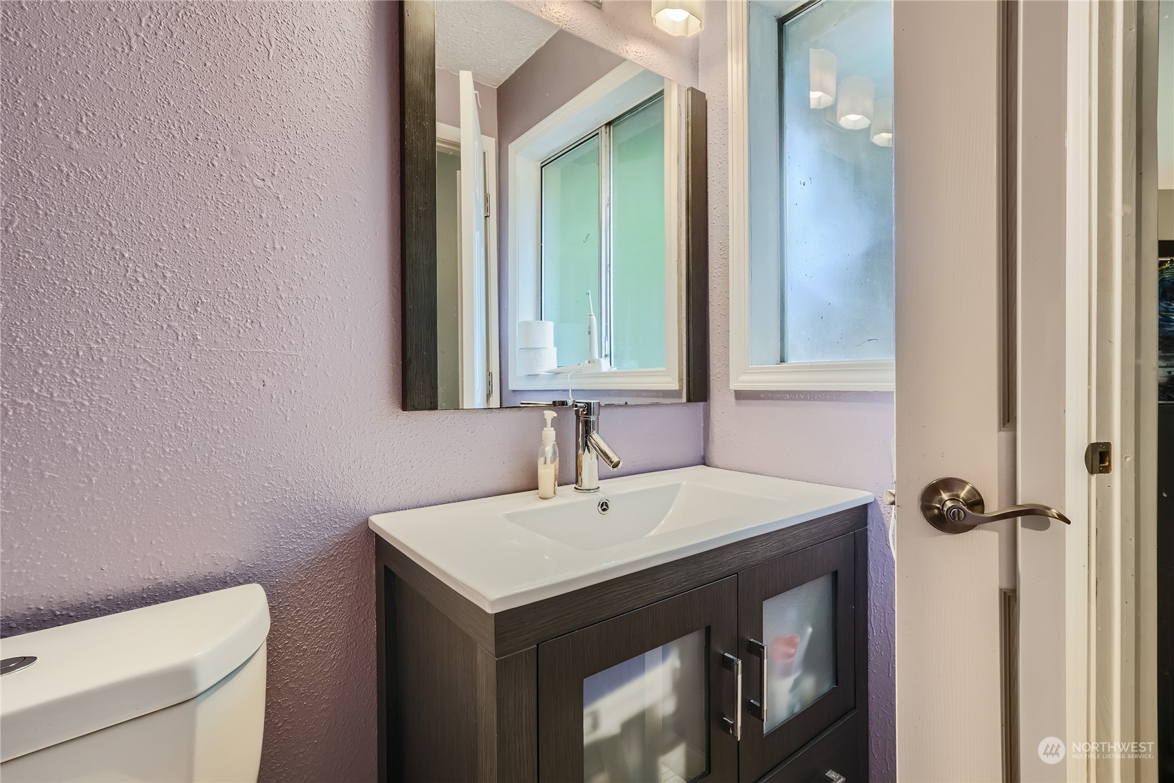 6935 24th Avenue Southwest Seattle, WA 98106 - Photo 18 of 27 a bathroom with a sink and a toilet