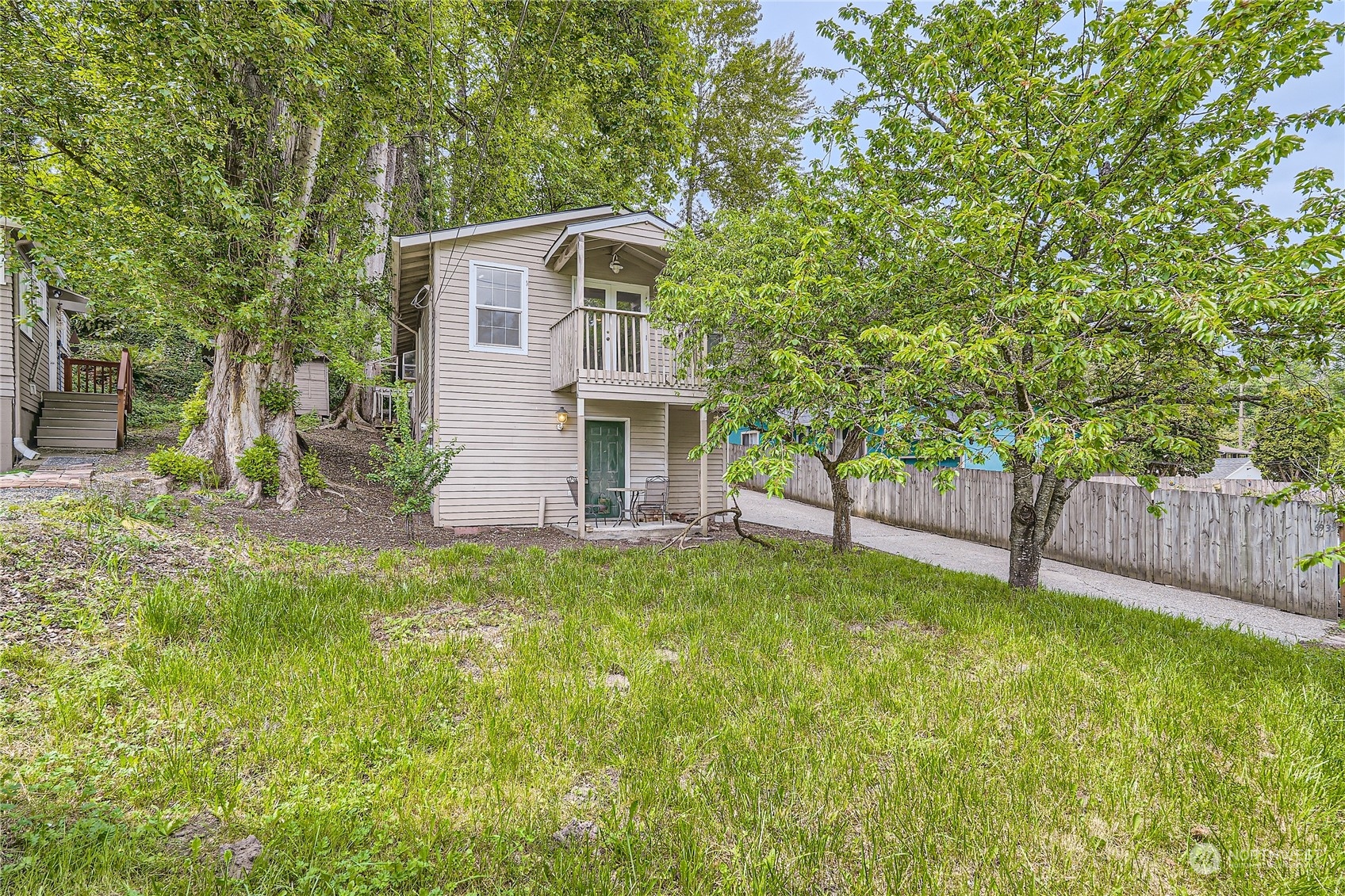 6935 24th Avenue Southwest Seattle, WA 98106 - Photo 2 of 27 a view of a house with backyard and a tree
