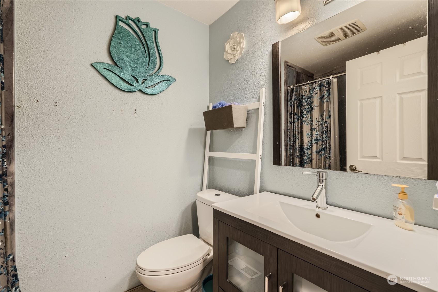 6935 24th Avenue Southwest Seattle, WA 98106 - Photo 21 of 27 a bathroom with a toilet a sink and mirror