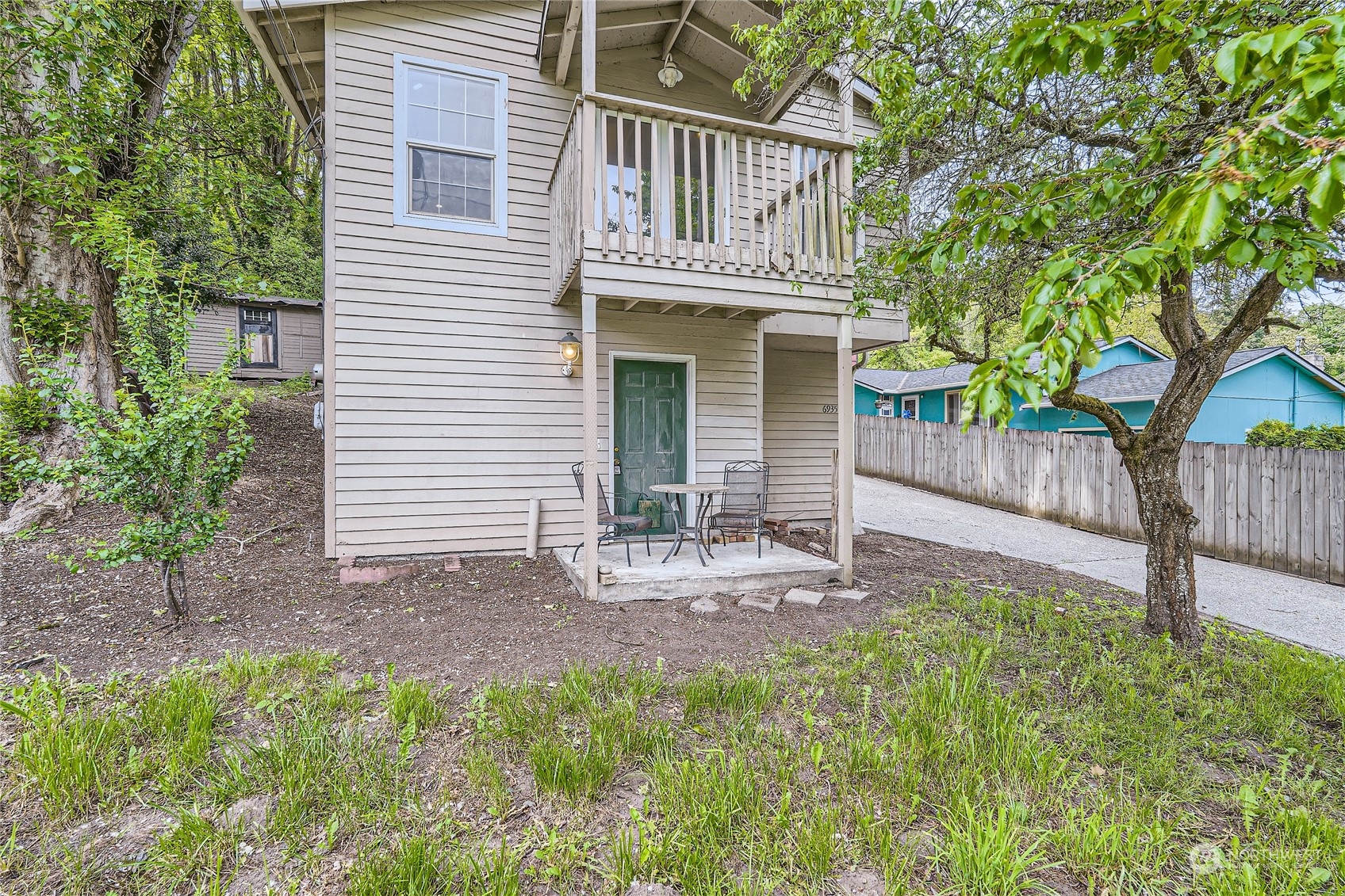 6935 24th Avenue Southwest Seattle, WA 98106 - Photo 24 of 27 a view of a house with a yard and wooden fence