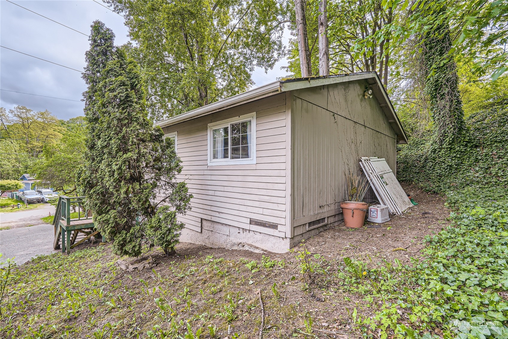6935 24th Avenue Southwest Seattle, WA 98106 - Photo 25 of 27 a view of a house with backyard and trees